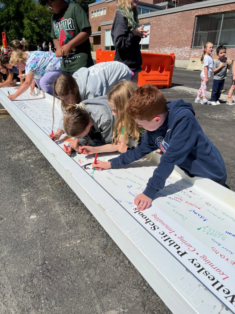 Fifth grade students sign the beam (1)
