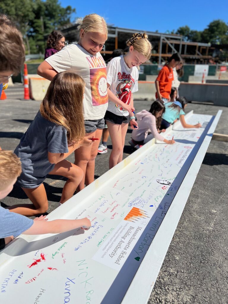 Fifth grade students sign the beam (2)