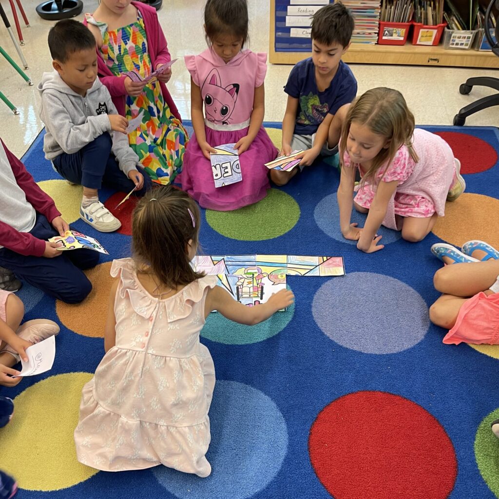 Students sitting on a rug with rainbow colors circles working on a puzzle