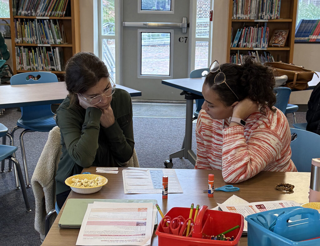 Two WPS Spanish teachers at a table working on curriculum together